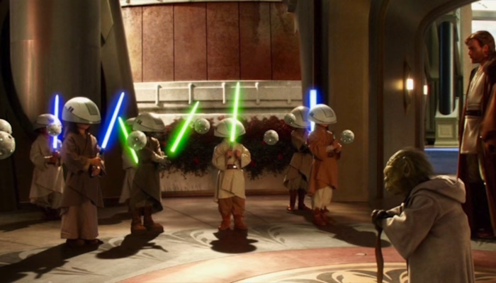 Several children holding lightsabers, and two men