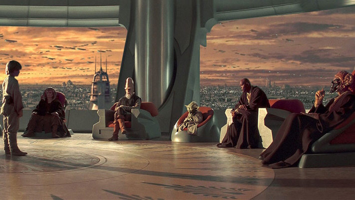 Several humans and alien beings are sitting in a spacious room.